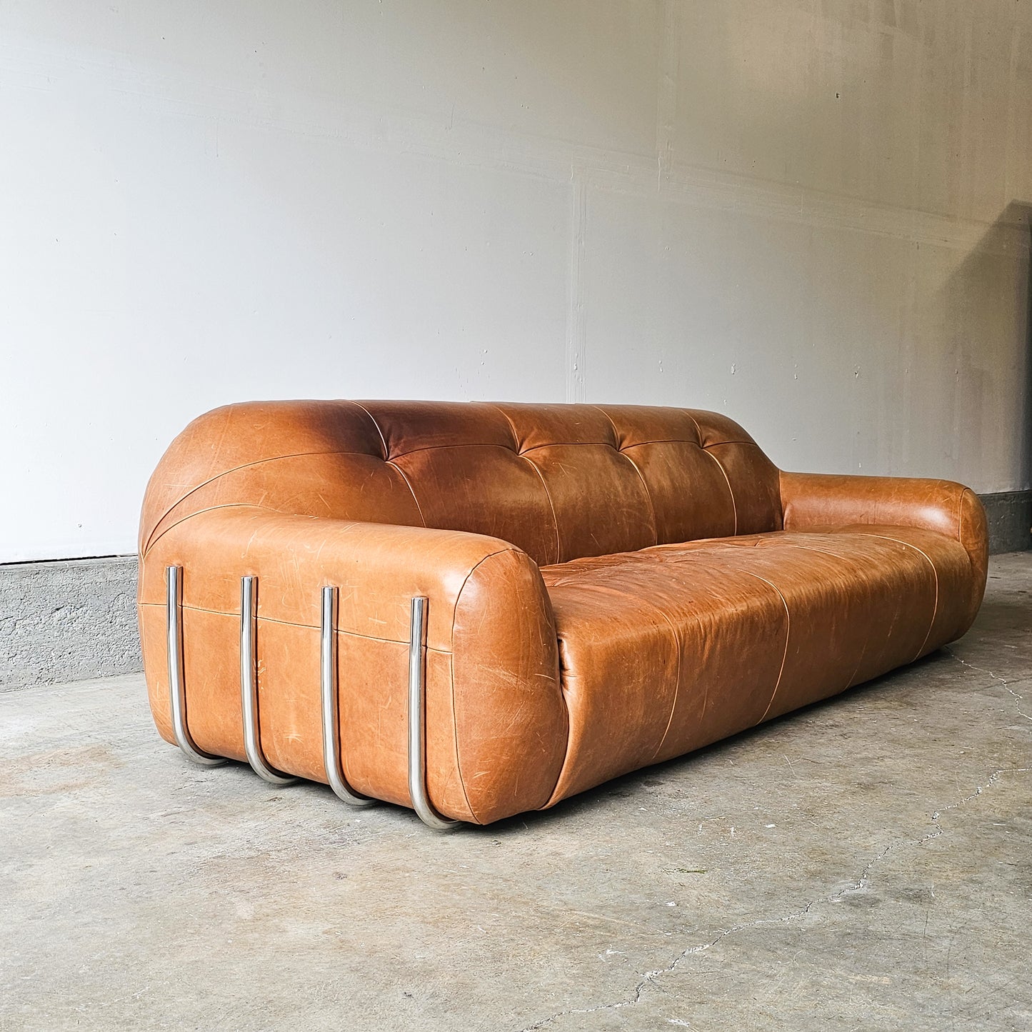 CB2 Chrome Brace Saddle leather tufted sofa-Discontinued Model
