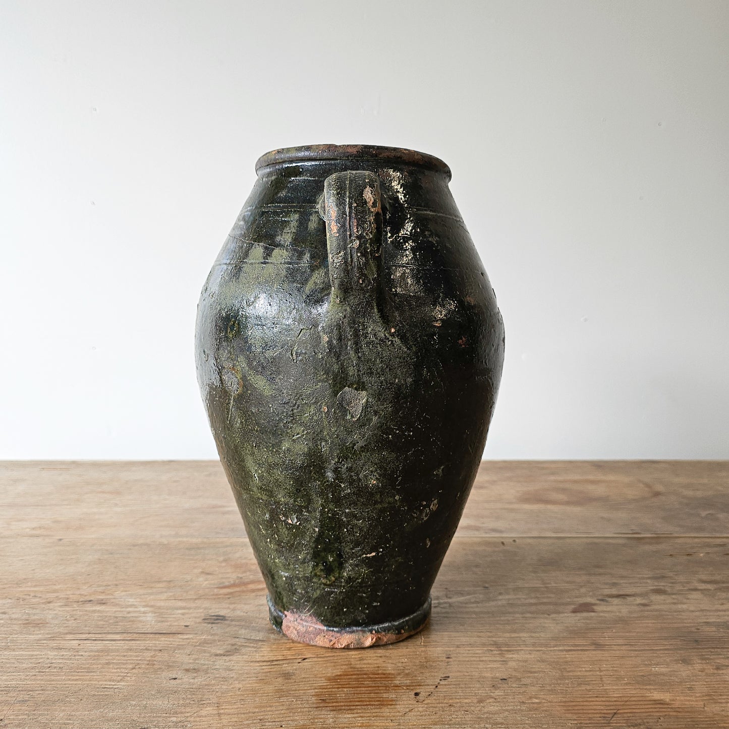 Vintage dark green glazed olive jug pottery