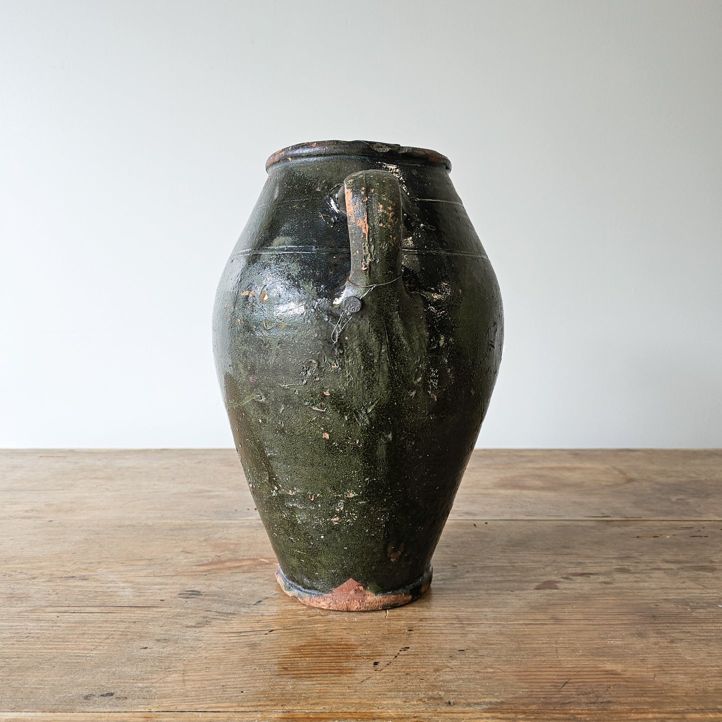 Vintage dark green glazed olive jug pottery