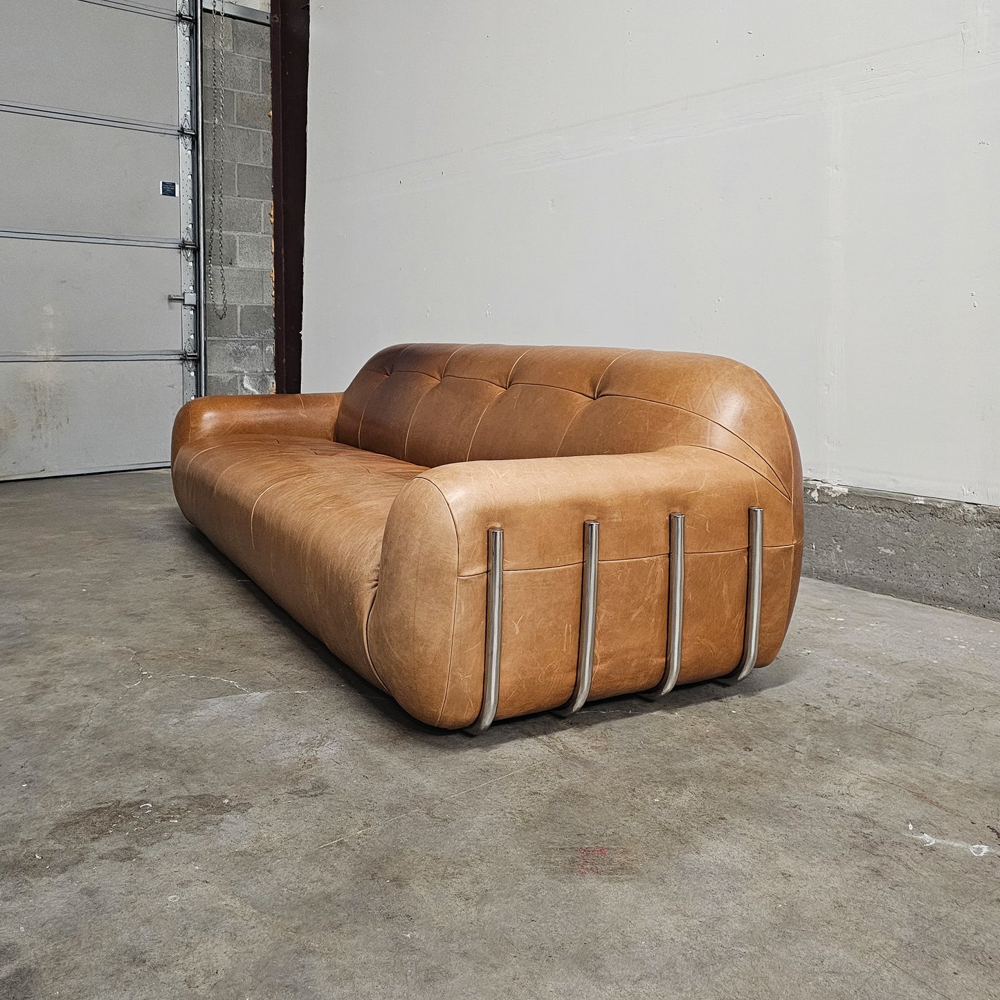 CB2 Chrome Brace Saddle leather tufted sofa-Discontinued Model