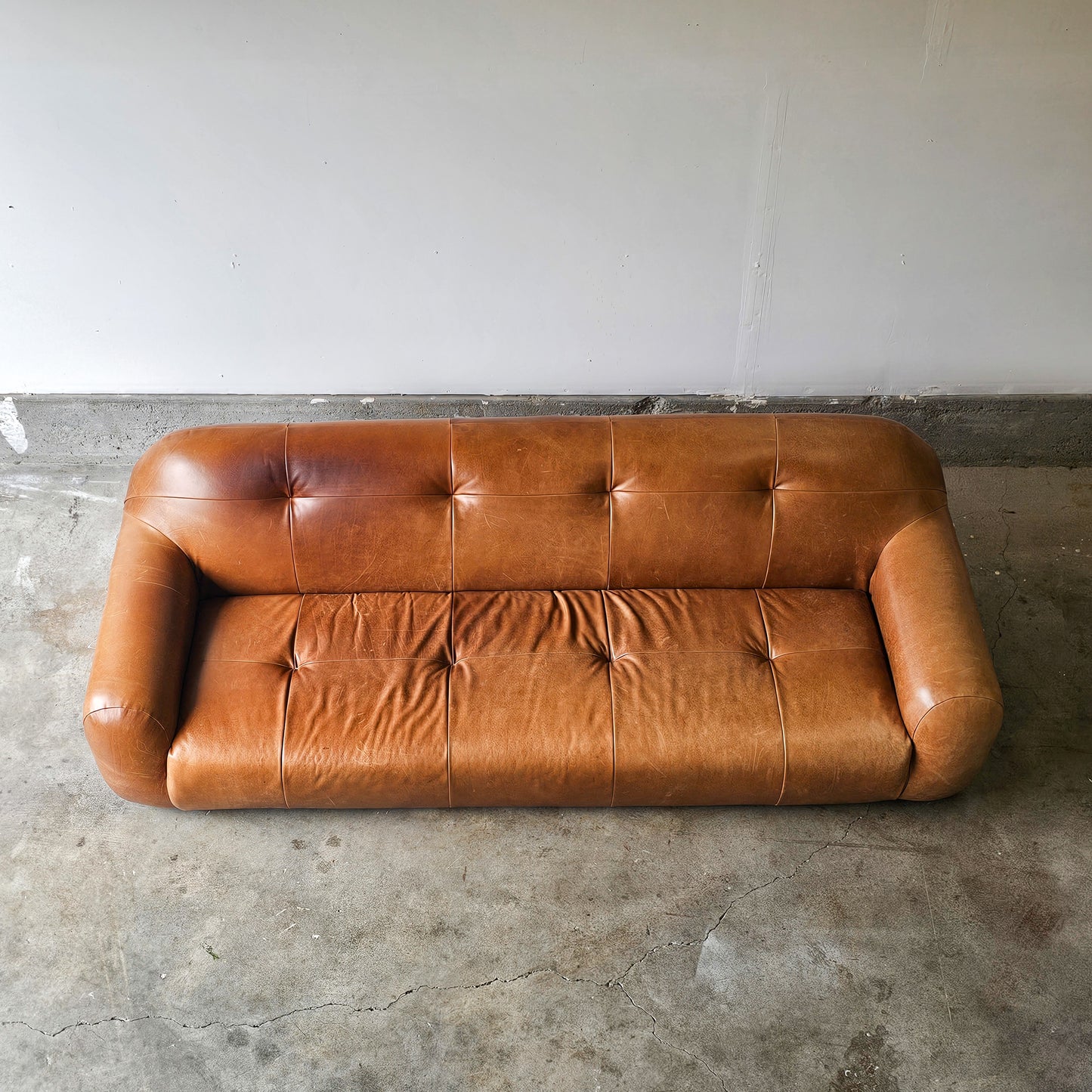 CB2 Chrome Brace Saddle leather tufted sofa-Discontinued Model