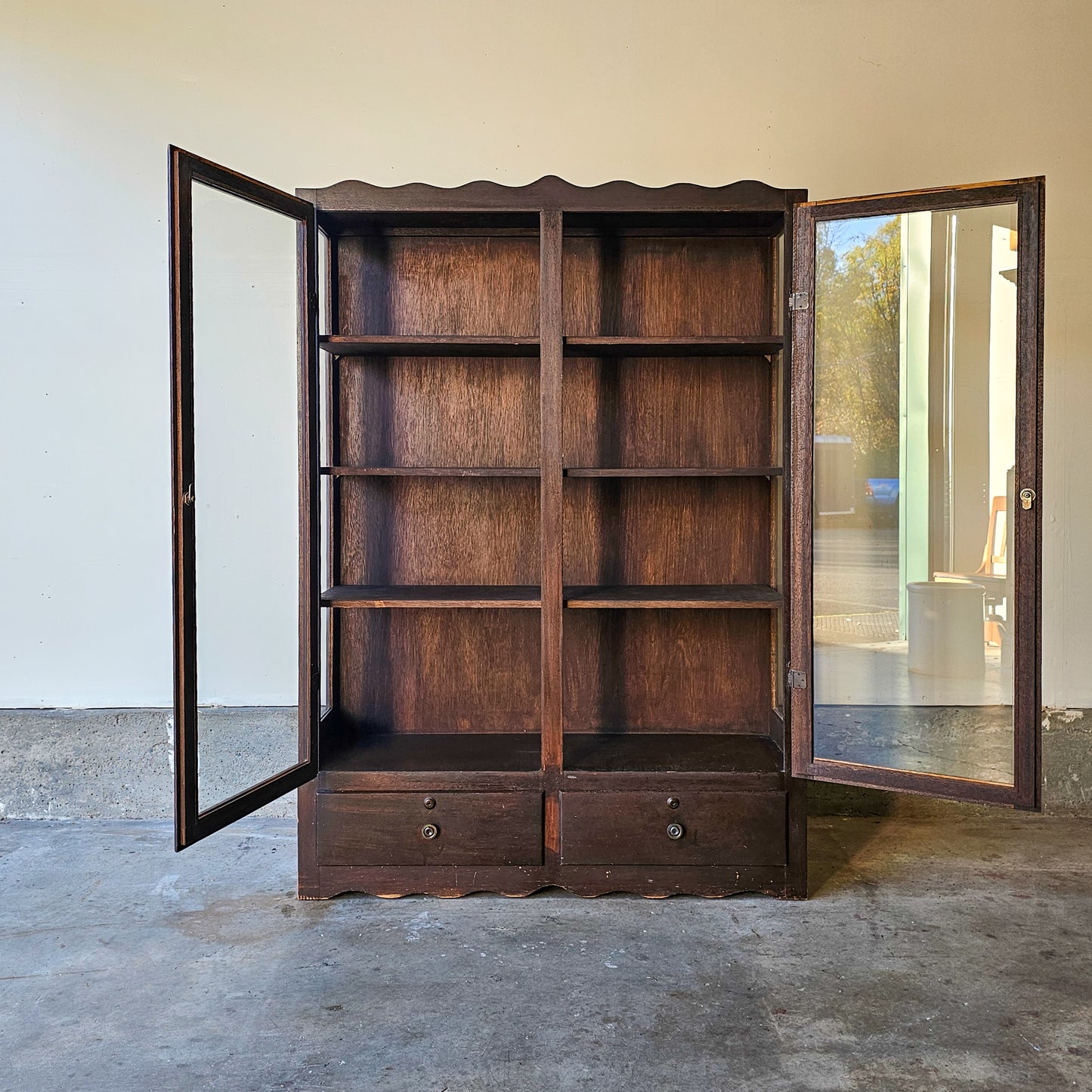 Antique glass-front scalloped trim cabinet