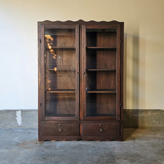Antique glass-front scalloped trim cabinet