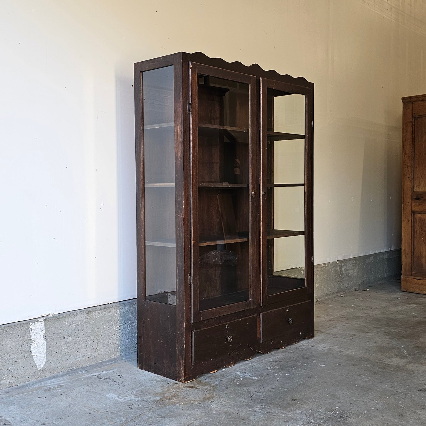 Antique glass-front scalloped trim cabinet